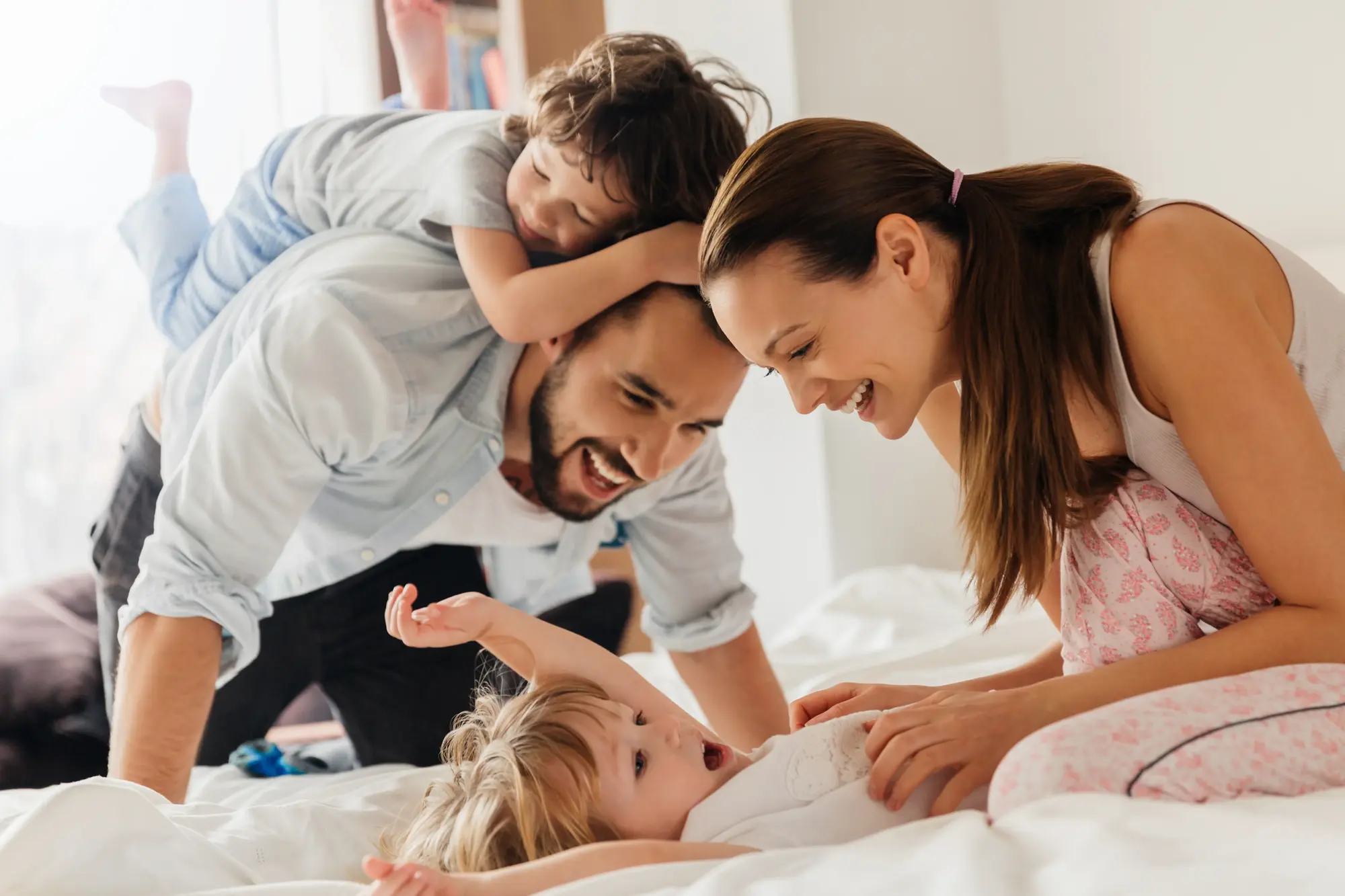 A family laughing together at home in the morning