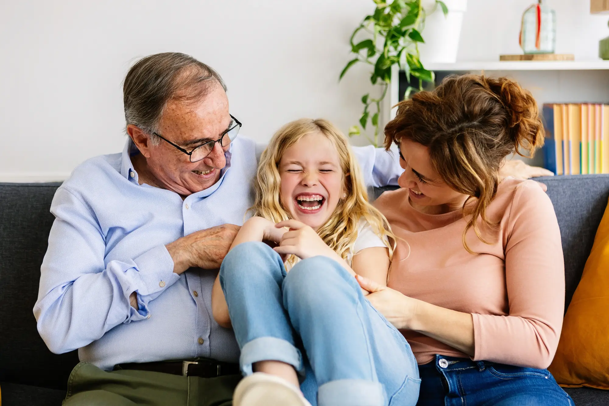 A smiling family sitting together outdoors