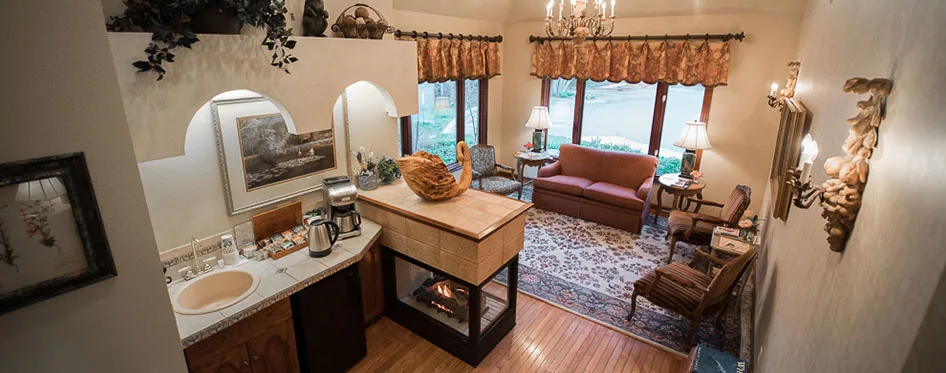 A cozy sitting area with a fireplace inside Peak Dentistry
